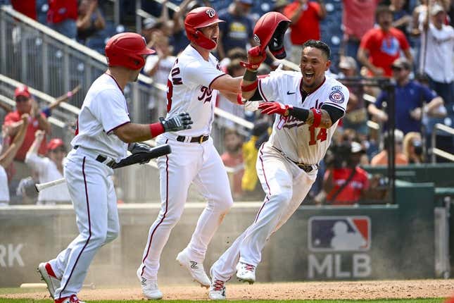 Aug 2, 2023; Washington, District of Columbia, USA; Washington Nationals pinch runner Ildemaro Vargas (14) reacts with left fielder Corey Dickerson (23) and third baseman Jake Alu (39) after scoring the game winning run against the Milwaukee Brewers at Nationals Park.