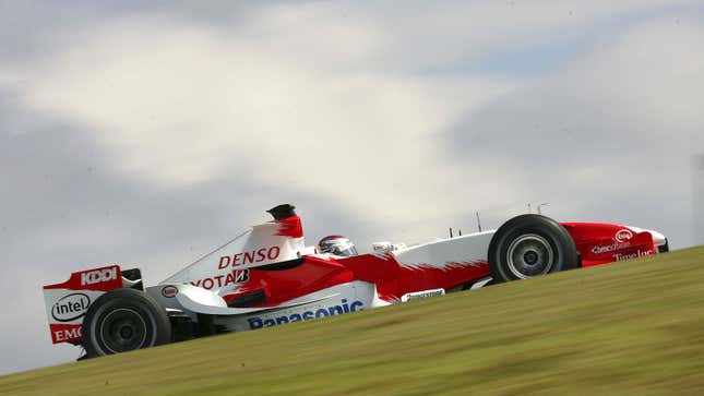 A photo of Jarno Trulli driving a Toyota F1 car in Brazil. 
