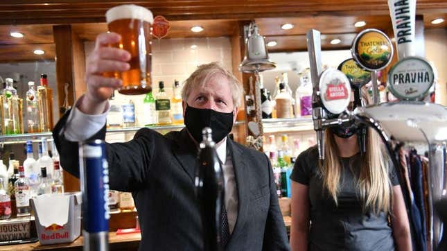 Boris Johnson holding a pint of ale at a British pub