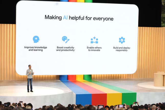 Alphabet CEO Sundar Pichai delivers the keynote address at the Google I/O developers conference at on stage. The screen behind him reads "Making AI helpful for everyone."