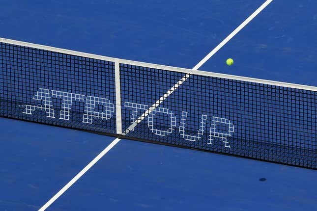 Aug 14, 2021; Mason, OH, USA; A view of the ATP Tour logo on the Center Court net as an official ball is in play during the Western and Southern Open tennis tournament at Lindner Family Tennis Center.