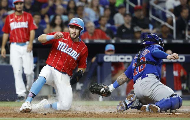 Apr 29, 2023; Miami, Florida, USA; Miami Marlins shortstop Garrett Hampson (1) scores against the Chicago Cubs during the third inning at loanDepot Park.