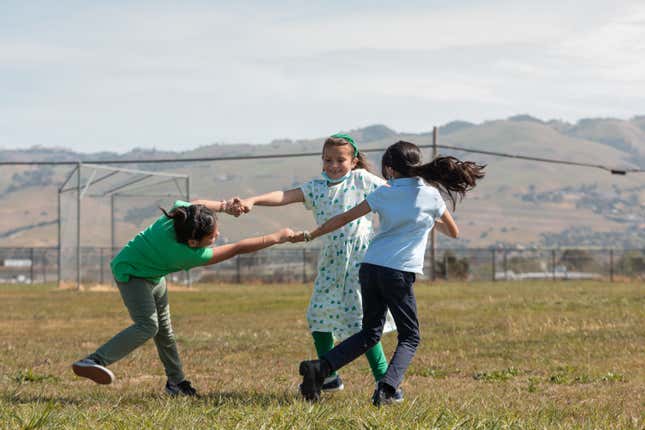 Holland, center, plays with friends on the athletic fields of Donald J. Meyer Elementary School.
