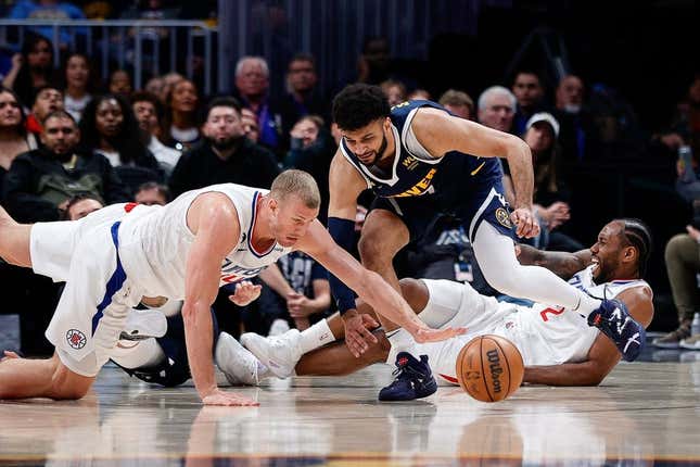 Feb 26, 2023; Denver, Colorado, USA; Los Angeles Clippers center Mason Plumlee (44) dives for the ball ahead of Denver Nuggets guard Jamal Murray (27) as forward Kawhi Leonard (2) reacts from the floor in the fourth quarter at Ball Arena.