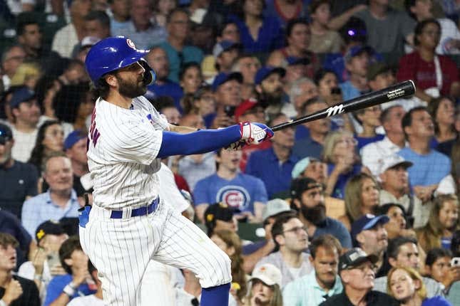 Aug 1, 2023; Chicago, Illinois, USA; Chicago Cubs shortstop Dansby Swanson (7) hits a two-run homer against the Cincinnati Reds during the fourth inning at Wrigley Field.