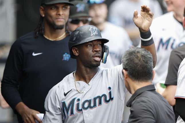June 10, 2023;  Chicago, Illinois, USA;  Miami Marlins center fielder Jonathan Davis (49) celebrates with teammates after scoring against the Chicago White Sox during the ninth inning at Guaranteed Rate Field.