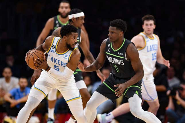 Mar 3, 2023; Los Angeles, California, USA; Los Angeles Lakers guard Malik Beasley (5) handles the ball against Minnesota Timberwolves guard Anthony Edwards (1) during the second quarter at Crypto.com Arena.