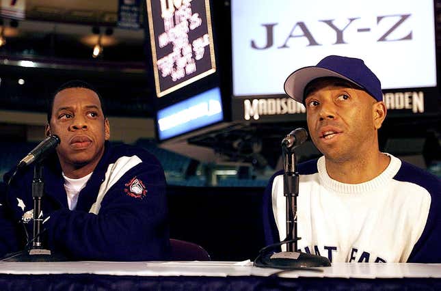 Rap artist Jay-Z (R) and Russell Simmons speaks to the media during a press confrence to announce Jay-Z’s concert at Madison Square Garden and the release of his final solo album “The Black Album”, September 24, 2003 in New York City.