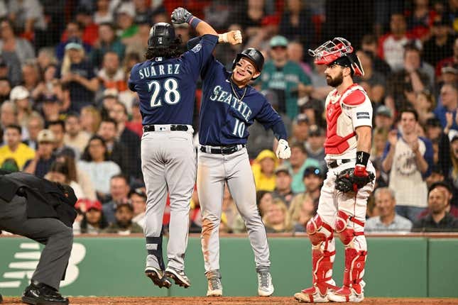 May 15, 2023; Boston, Massachusetts, USA; Seattle Mariners third baseman Eugenio Suarez (28) celebrates with left fielder Jarred Kelenic (10) after hitting a two-run home run against the Boston Red Sox during the eighth inning at Fenway Park.