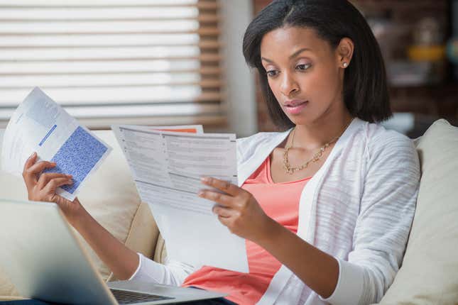 Black woman looking at bills
