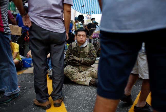 A pro-democracy protester guards a tent from possible attack by anti- protesters in Mong Kok on Oct. 5.