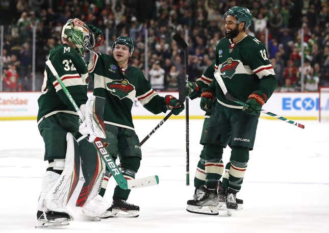 Feb 28, 2023; Saint Paul, Minnesota, USA;  Minnesota Wild goaltender Filip Gustavsson (32) celebrates his victory over the New York Islanders with defenseman Calen Addison (2) and left wing Jordan Greenway (18) after the shootout period at Xcel Energy Center. Minnesota Wild win 2-1 in shootout.