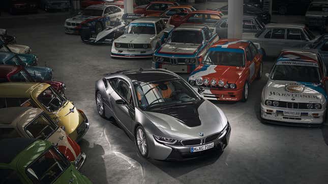 A photo of a BMW i8 coupe in a room full of vintage BMW cars. 