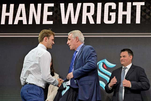 Jul 7, 2022; Montreal, Quebec, CANADA; Shane Wright shakes hands with Seattle Kraken general manager Ron Francis after being selected as the number four overall pick to the Seattle Kraken in the first round of the 2022 NHL Draft at Bell Centre.