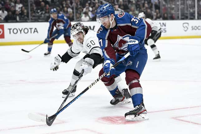 Apr 8, 2023; Los Angeles, California, USA; Colorado Avalanche left wing J.T. Compher (37) handles the puck in front of Los Angeles Kings defenseman Sean Durzi (50) during the first period at Crypto.com Arena.