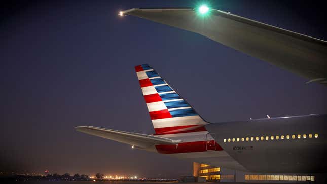 An illuminated tail of an American Airlines flight