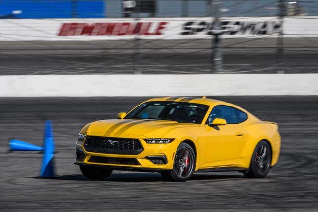 A yellow 2024 Ford Mustang EcoBoost on an autocross course at Irwindale Raceway in Irwindale, CA. 