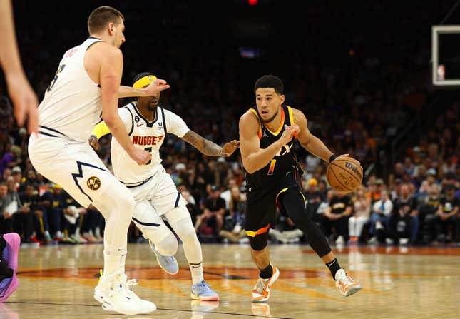 May 7, 2023; Phoenix, Arizona, USA; Phoenix Suns guard Devin Booker (1) against the Denver Nuggets in the first half during game four of the 2023 NBA playoffs at Footprint Center.