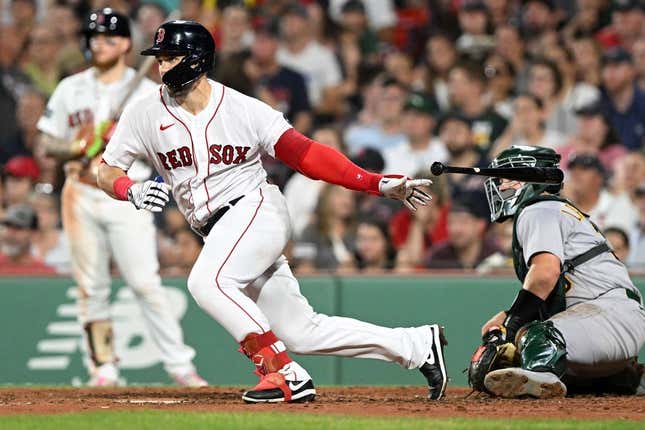 Jul 7, 2023; Boston, Massachusetts, USA; Boston Red Sox center fielder Adam Duvall (18) hits a RBI single against the Oakland Athletics during the seventh inning at Fenway Park.
