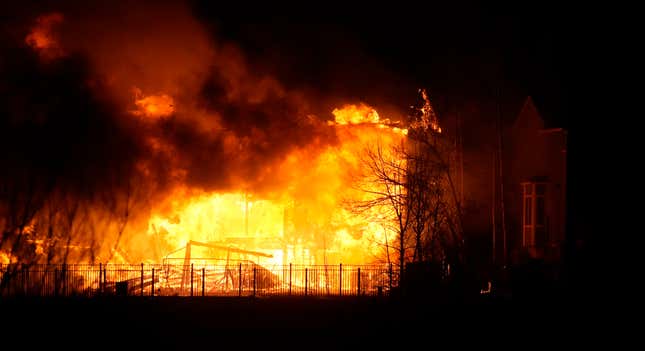 Homes burn at night as a wildfire rips through a development near Rock Creek Village near Broomfield, Colorado.