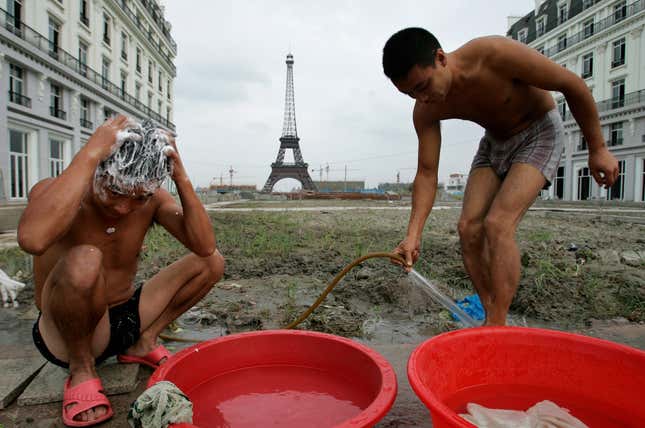 Construction workers bathe near apartment buildings in Tianducheng.