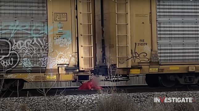 A child crawls under a stalled train to reach her elementary school in Hammond, Illinois. 