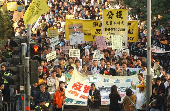 More than 1,000 people march in downtown Hong Kong on Sunday, Jan. 23, 2005, to demand full democracy and social justice in the Chinese territory. The protesters chanted, "Direct elections in 2007 and 2008," the years in which Hong Kong is due a to get new leader and legislature.