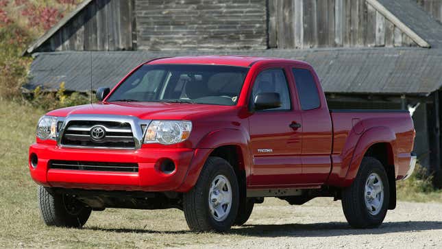 A photo of a red second generation Toyota Tacoma truck. 