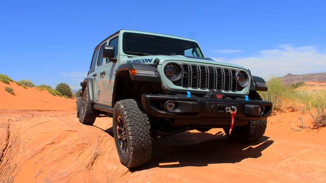 A photo of a blue/grey Jeep Wrangler on a trail. 