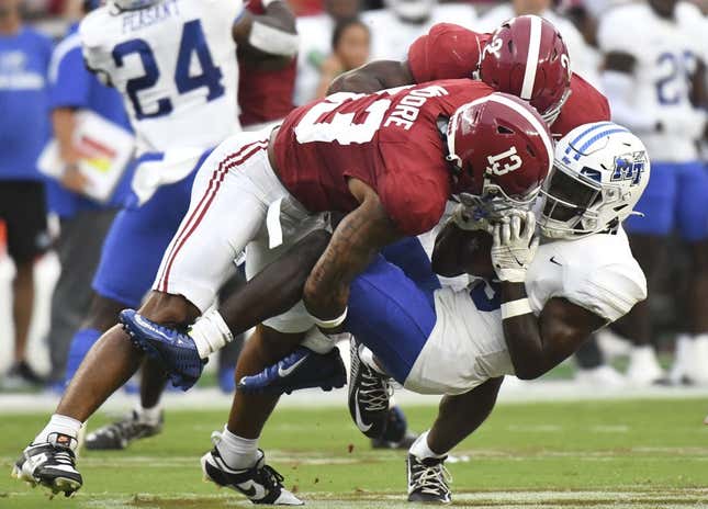Sep 2, 2023; Tuscaloosa, Alabama, USA;  Alabama Crimson Tide defensive back Malachi Moore (13) and defensive back Caleb Downs (2) combine to tackle Middle Tennessee Blue Raiders wide receiver Elijah Metcalf (9) during the first half at Bryant-Denny Stadium.