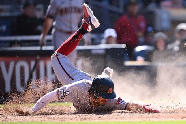 Apr 4, 2023; San Diego, California, USA; Arizona Diamondbacks third baseman Josh Rojas (10) steals home during the eighth inning against the San Diego Padres at Petco Park.