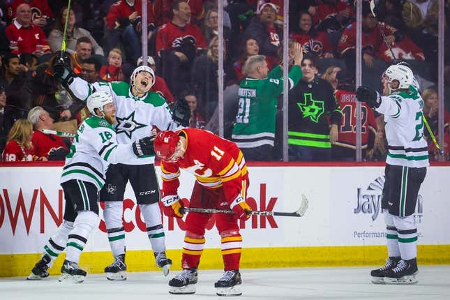 Mar 18, 2023; Calgary, Alberta, CAN; Dallas Stars left wing Jason Robertson (21) celebrates his goal with teammates against the Calgary Flames during the overtime period at Scotiabank Saddledome.