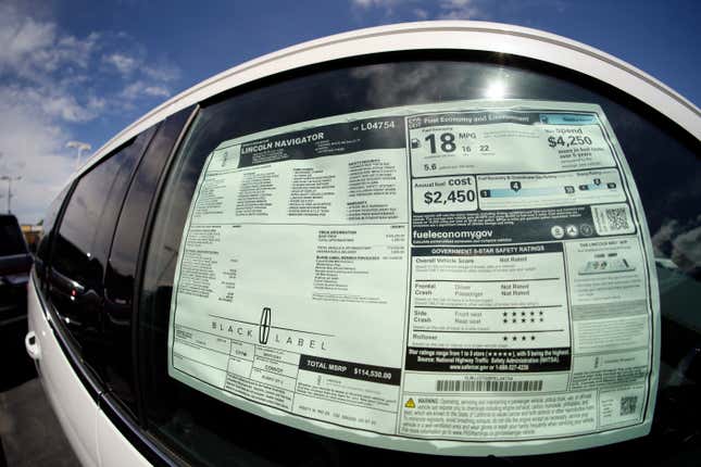 File - The sticker price is displayed in the window of an unsold 2023 Navigator sports-utility vehicle at a Lincoln dealership on June 18, 2023, in Englewood, Colo. The strike by auto workers is almost certain to lead to higher prices for car buyers; it&#39;s only a matter of whether panic buying will make dealer lots look empty sooner than analysts expect. (AP Photo/David Zalubowski, File)