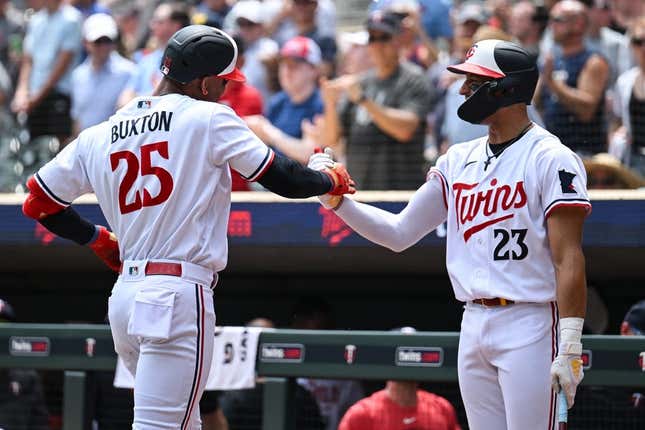Jun 22, 2023; Minneapolis, Minnesota, USA; Minnesota Twins designated hitter Byron Buxton (25) and third baseman Royce Lewis (23) react after Buxton hit his second home run of the day during the third inning at Target Field.