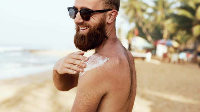 guy applying sunscreen