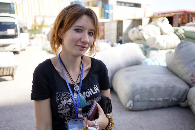 Valerka Vojutulevitsh, the 22-year-old from Almaty, Kazakhstan, stands in front of the bulk packages of goods sold in Khorgos ICBC.