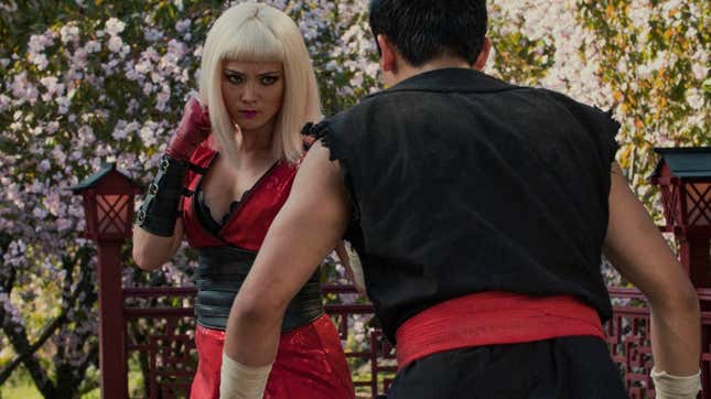A still from Black Mirror of a blond woman engaging in martial arts with a man in a black karate gi.