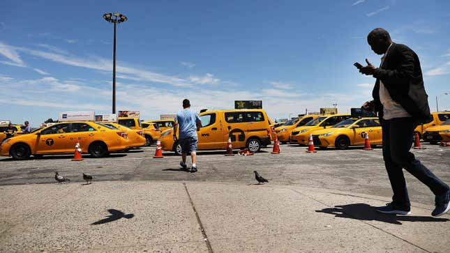 Taxi drivers wait at the holding lot at JFK International Airport