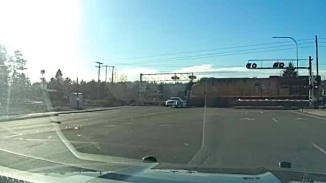 Image for article titled Watch a Fleeing Suspect&#39;s Cadillac Barely Miss an Oncoming Train