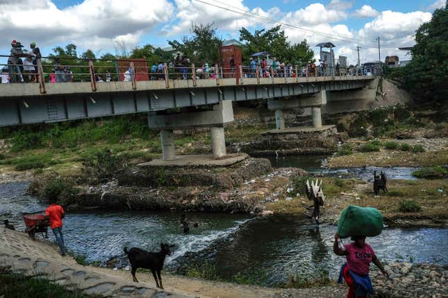FILE - People bathe in the Massacre River, named for a bloody battle between Spanish and French colonizers in the 1700s, on the border with Haiti in Ouanaminthe, Dominican Republic, Nov. 19, 2021. The Dominican Republic&#39;s President Luis Abinader announced on Sept. 11, 2023 he has suspended issuing visas to Haitians. (AP Photo/Matias Delacroix, File)