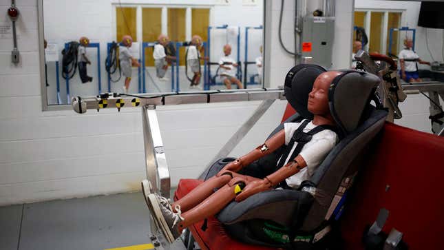 A photo of a child crash test dummy in a car seat. 
