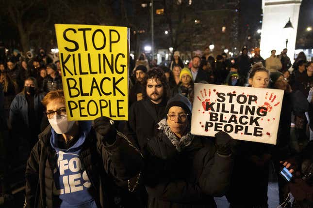Demonstrators hold signs during a protest at Washington Square Park in New York on Jan. 28, 2023, in response to the death of Tyre Nichols, who died after being beaten by Memphis police during a traffic stop.