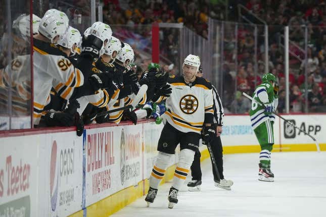 Mar 26, 2023; Raleigh, North Carolina, USA;  Boston Bruins center Charlie Coyle (13) scores a shoot out goal against the Carolina Hurricanes (31) at PNC Arena.