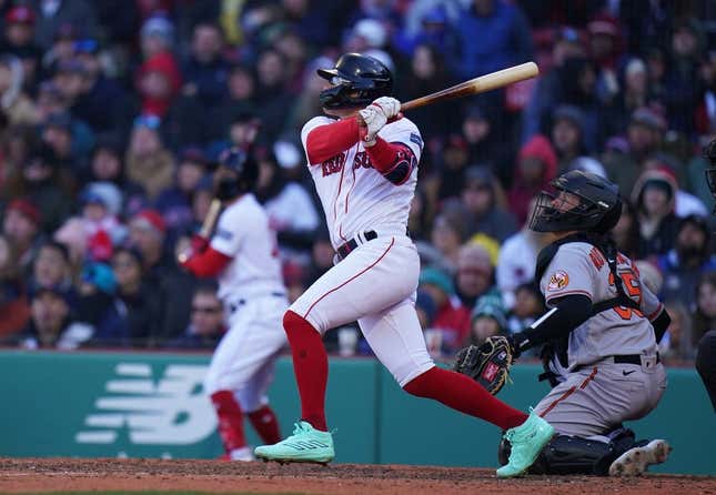 Apr 2, 2023; Boston, Massachusetts, USA; Boston Red Sox shortstop Enrique Hernandez (5) singles to right field to drive in a run against the Baltimore Orioles in the seventh inning at Fenway Park.