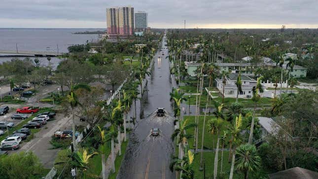 In this aerial view, vehicles make their way through a flooded area after Hurricane Ian passed through on September 29, 2022 in Fort Myers, Florida. 