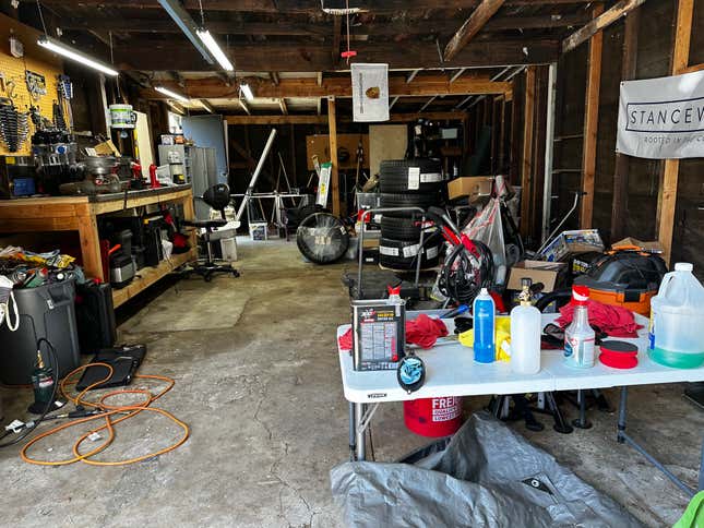 A messy garage with stuff everywhere.