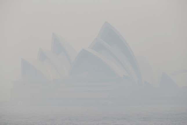 Thick smoke from wildfires shroud the Opera House in Sydney, Australia, Tuesday, Dec. 10, 2019. Hot dry conditions have brought an early start to the fire season.
