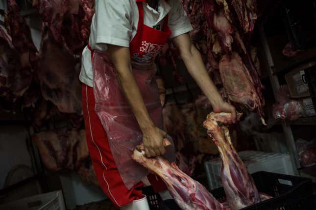 Butchers work at the popular Lapa Market March 20, 2017 in Sao Paulo, Brazil.