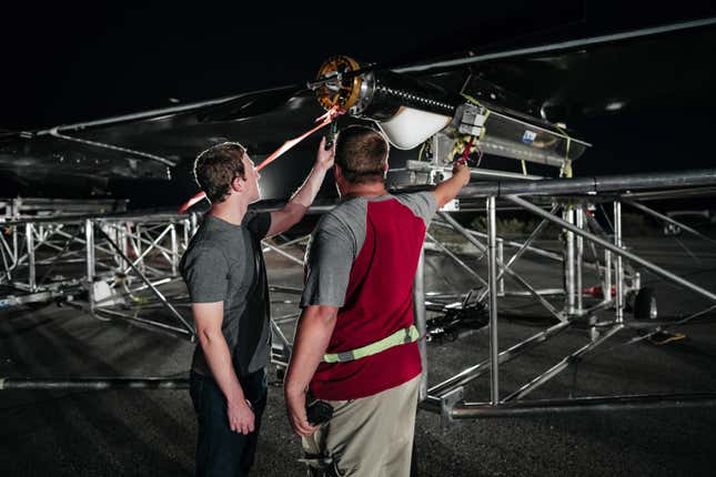 CEO Mark Zuckerberg inspecting one of the drone’s engines prior to its flight.