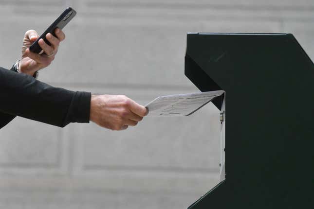 PHILADELPHIA, PA - OCTOBER 27: A man photographs himself depositing his ballot in an official ballot drop box while a long line of voters queue outside of Philadelphia City Hall at the satellite polling station on October 27, 2020, in Philadelphia, Pennsylvania. With the election only a week away, this new form of in-person voting by using mail ballots has enabled tens of millions of voters to cast their ballots before the general election. Vying to recapture the Keystone State’s vital 20 electoral votes in order to bolster his reelection prospects, President Donald Trump held three rallies throughout Pennsylvania yesterday.